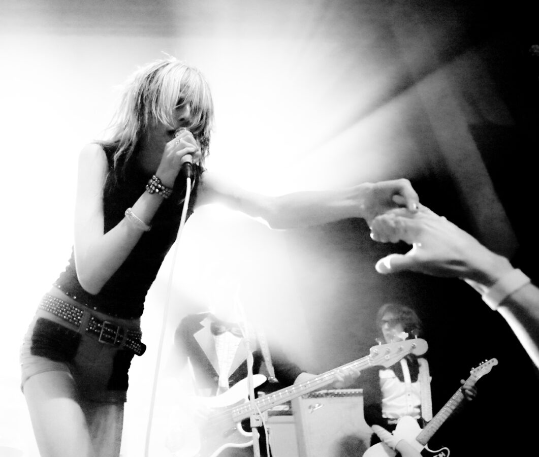 Arrow de Wilde of Starcrawler holding an audience member's hand